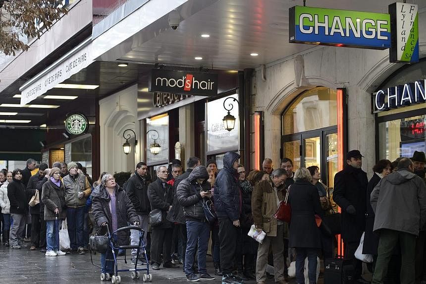 A day after the Swiss National Bank abandoned the Swiss franc's peg to the euro last Thursday, sending the franc soaring, queues like this formed at currency exchange offices in Geneva.
