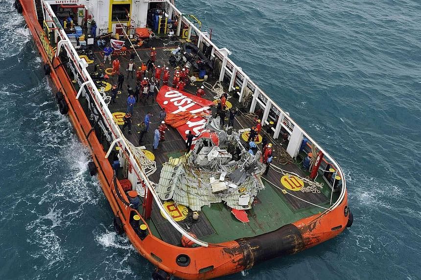 The tail of AirAsia QZ8501 passenger plane is seen on the deck of the Indonesian Search and Rescue (Basarnas) ship Crest Onyx after it was lifted from the sea bed, south of Pangkalan Bun, Central Kalimantan on Jan 10, 2015. -- PHOTO: REUTERS