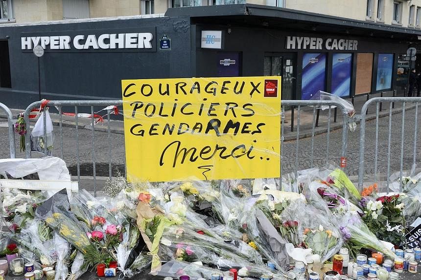 Flowers, candles and a placard reading "Brave Police officers, gendarmes, thank you" are found placed outside a Jewish supermarket on Jan 16, 2015,&nbsp;as a tribute to the victims of an attack by gunman Amedy Coulibaly.&nbsp;France has formally char
