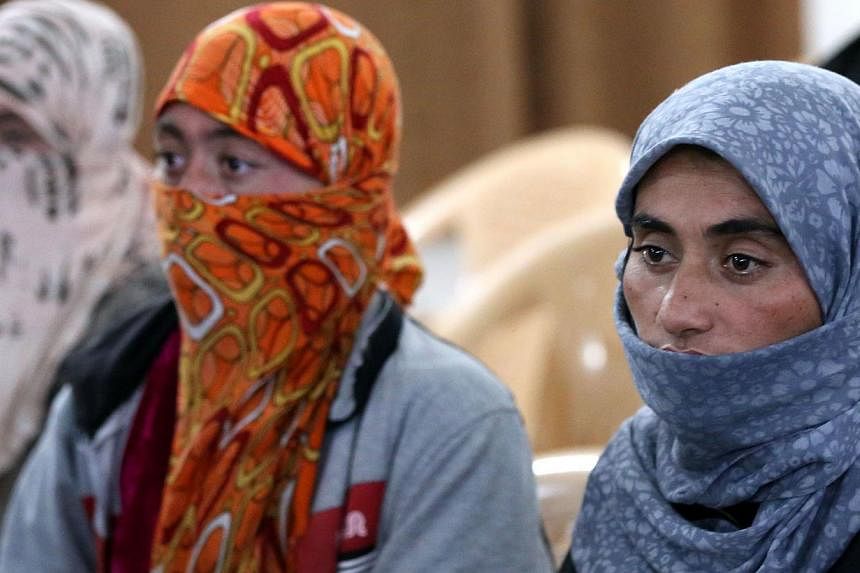 Yazidi women at Al-Tun Kopri health centre, located halfway between the northern Iraqi city of Kirkuk and Arbil, after they were released on Jan 17, 2015 after being held by ISIS militants for more than five months. The terrorist group is now said to
