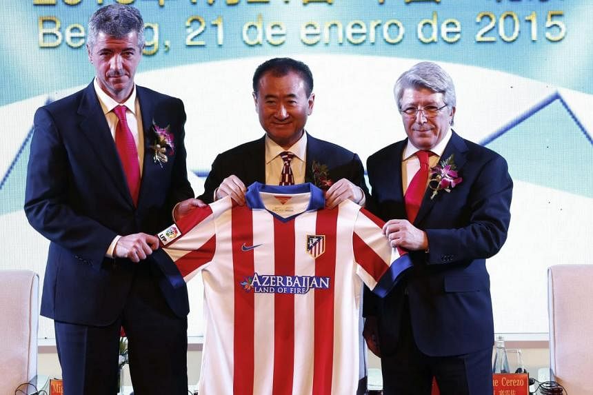 (From left) Atletico Madrid CEO Miguel Angel Gil, Wanda Group chairman Wang Jianlin and Atletico Madrid president Enrique Cerezo during an agreement ceremony in Beijing, China on Jan 21, 2015. -- PHOTO: EPA