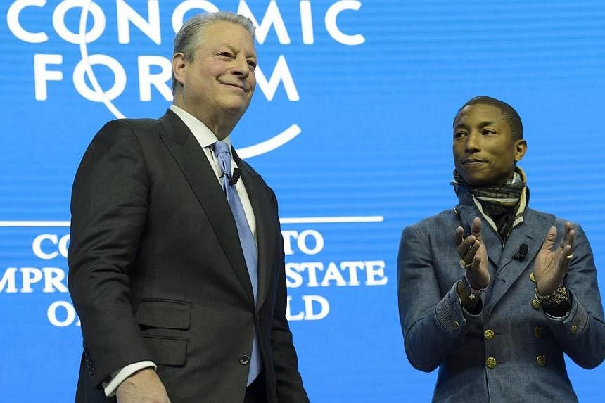 Former US vice-president Al Gore (left) speaks next to rapper Pharell Williams, during a panel session on the first day of the 45th Annual Meeting of the World Economic Forum (WEF), in Davos, Switzerland, on Jan 21, 2015. -- PHOTO: EPA