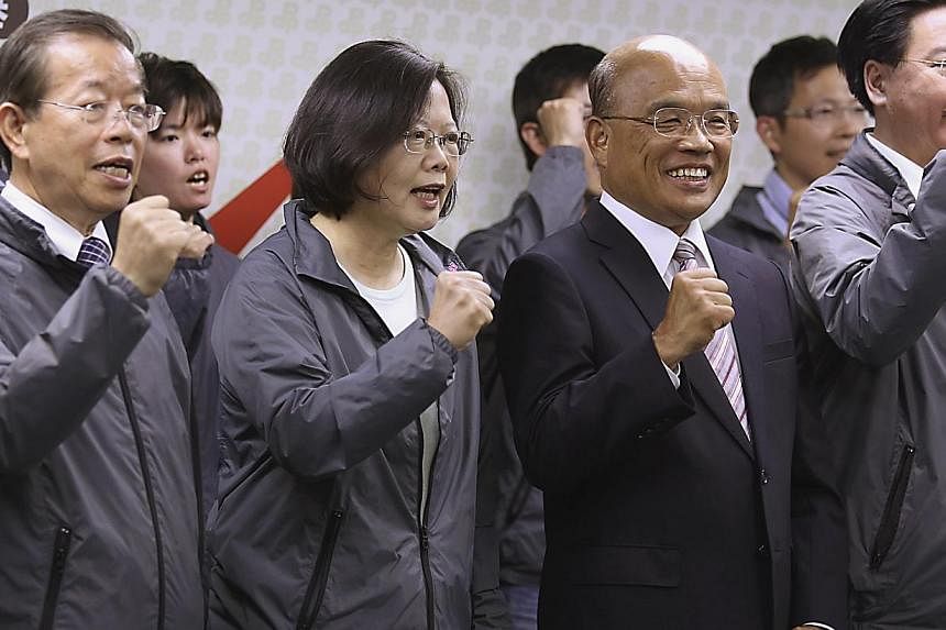 Taiwan's main opposition Democratic Progressive Party (DPP) Chairperson Tsai Ing-wen (second left) and party officials celebrate winning the local elections in Taipei on Nov 29, 2014. The DPP on Wednesday, Jan 21, 2015, said&nbsp;relations with China