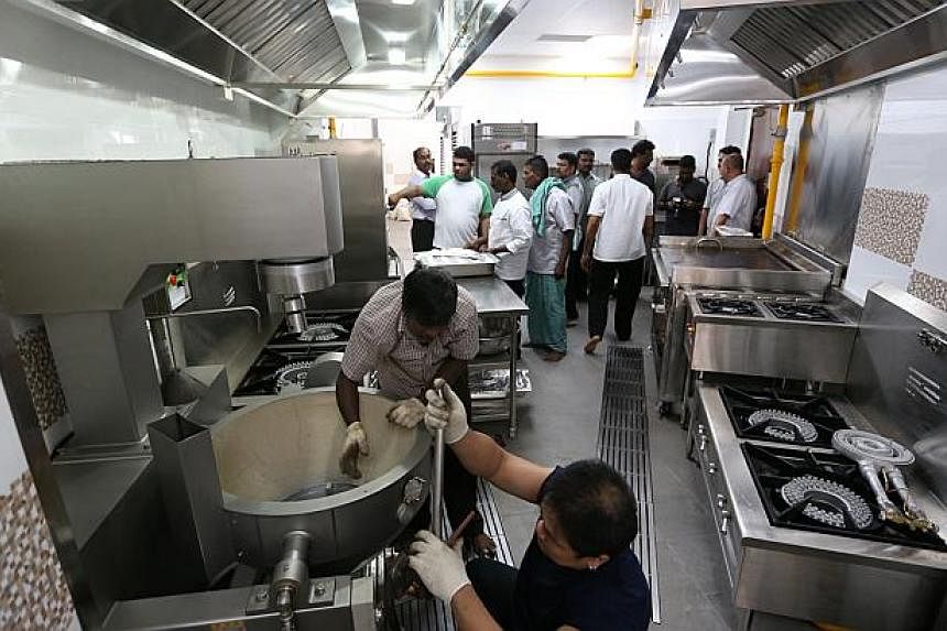 The Sri Senpaga Vinayagar temple's new kitchen is equipped with a 150-litre machine for curries, an automated vegetable cutter, automated rice washer and combi-oven steamer which can produce 250 pieces of idli (steamed cakes) in 10 minutes. -- ST PHO