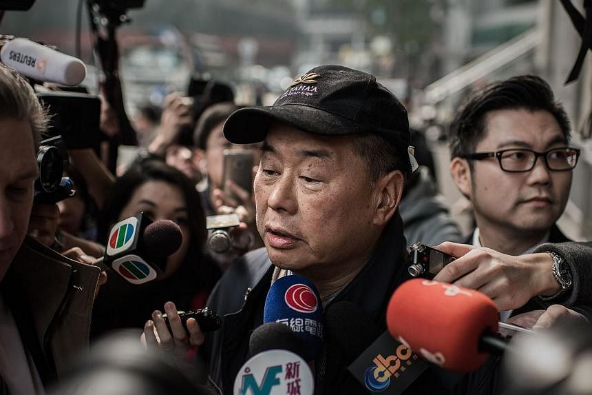 Media tycoon Jimmy Lai after walking out of the Wanchai police station in Hong Kong on Jan 21, 2015. -- PHOTO: AFP&nbsp;