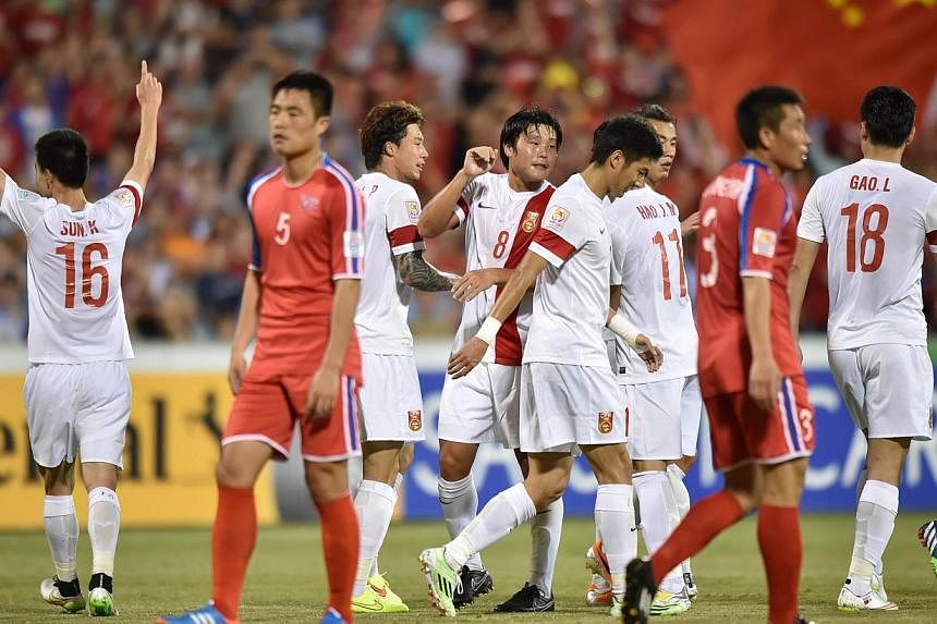 China (in white) celebrate scoring their second goal against North Korea during their Group B football match of the AFC Asian Cup in Canberra on Jan 18, 2015. North Korea have withdrawn from a friendly tournament in Thailand next month because of int