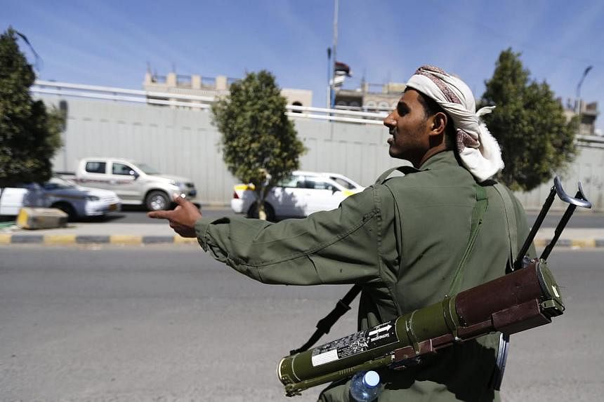 A Houthi fighter mans a checkpoint on a road leading to the Presidential Palace in Sanaa, Yemen, on Jan 20, 2015.&nbsp;Authorities in Yemen's second city Aden shut its international airport on Wednesday, Jan 21, in protest against attacks by Shi'ite 
