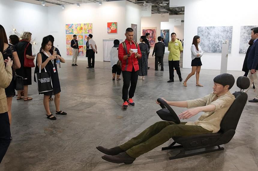 Visitors looking at the are pieces at the the fifth edition of Art Stage Singapore, during a private viewing at the Marina Bay Sands Expo and Convention Centre on Jan 21, 2015.&nbsp;-- ST PHOTO:&nbsp;ONG WEE JIN