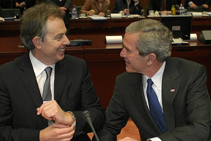 Former US leader George W. Bush with former British PM Tony Blair during the EU-US Leaders' Meeting in Brussels in 2005. Publication has been slowed by disagreement over the release of communications between former British prime minister Tony Blair a