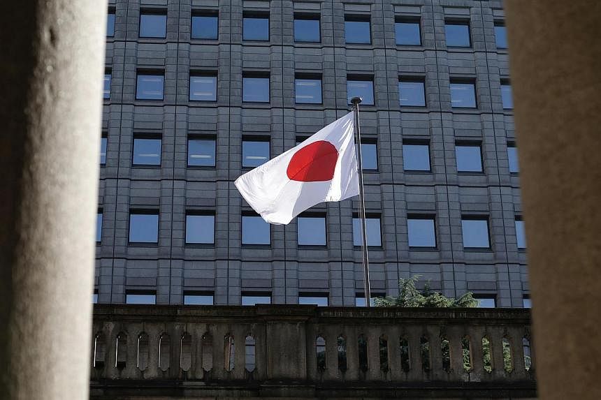 The Bank of Japan has decided to maintain its pledge to increase base money, or cash and deposits at the central bank and extended the deadline of two loan programme. -- PHOTO: REUTERS