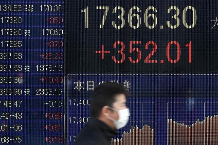 An electric quotation board flashing the Nikkei key index of the Tokyo Stock Exchange in front of a securities company in Tokyo on Jan 20, 2015. Asian shares held firm and the euro stayed under pressure on Wednesday as investors counted on the Europe