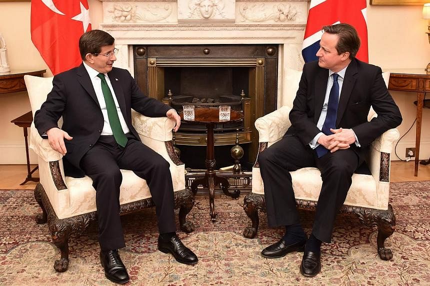 British Prime Minister David Cameron (right) meeting Turkish Prime Minister Ahmet Davutoglu (left) at No. 10, Downing Street, in central London on Jan 20, 2015. -- PHOTO: AFP