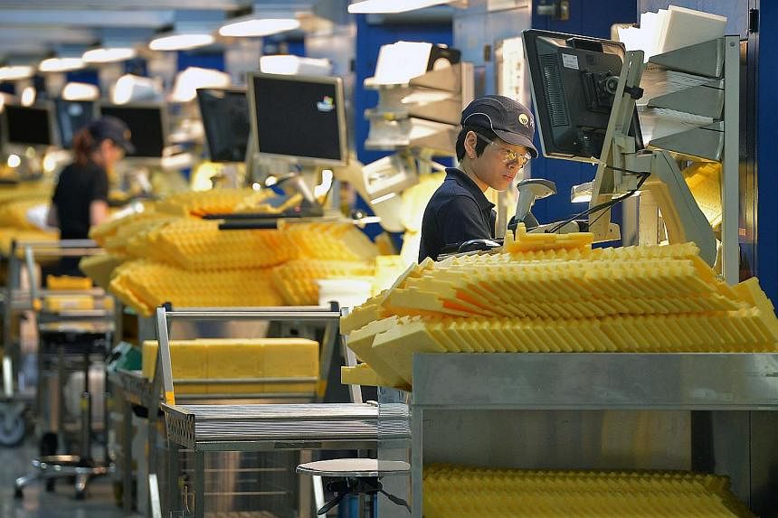 A wafer production line at a manufacturing facility in Tuas. KPMG has joined the host of voices from the business community calling for government productivity schemes to be enhanced in the upcoming Budget. -- PHOTO: ST FILE