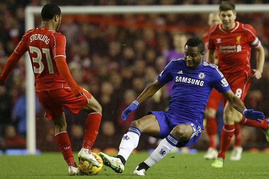 Chelsea's John Obi Mikel challenges Liverpool's Raheem Sterling (left) during their English League Cup semi-final first leg soccer match at Anfield in Liverpool, northern England Jan 20, 2015. -- PHOTO: REUTERS