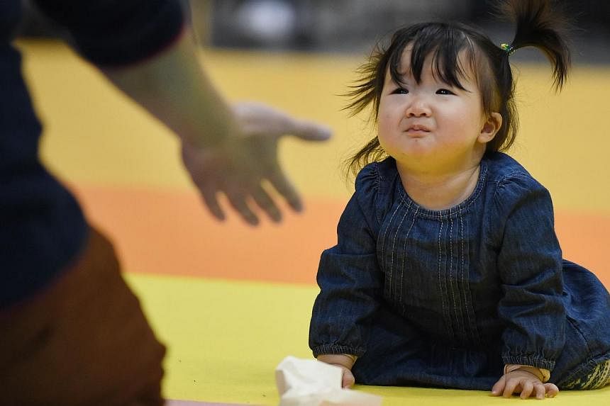 Fertility rates in Japan bottomed out at 1.26 children per woman in 2005, and have been rising since - despite the sharp recession and natural disasters that happened in the meantime. -- PHOTO: AFP