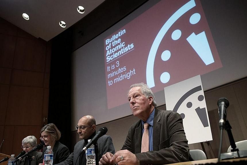 Scientists from the group Bulletin of the Atomic Scientists speak during a press conference after updating the Doomsday Clock on Jan 22, 2015 in Washington, DC.&nbsp;&nbsp;-- PHOTO: AFP&nbsp;