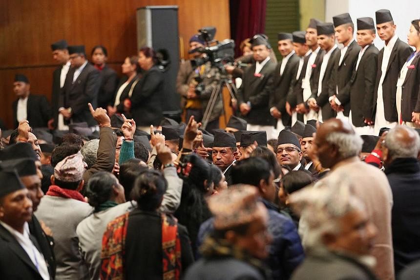 Constitution assembly members shout during the meeting at the parliament on the final day to draft the new constitution in Kathmandu, Nepal, on Jan 22, 2015. -- PHOTO: EPA