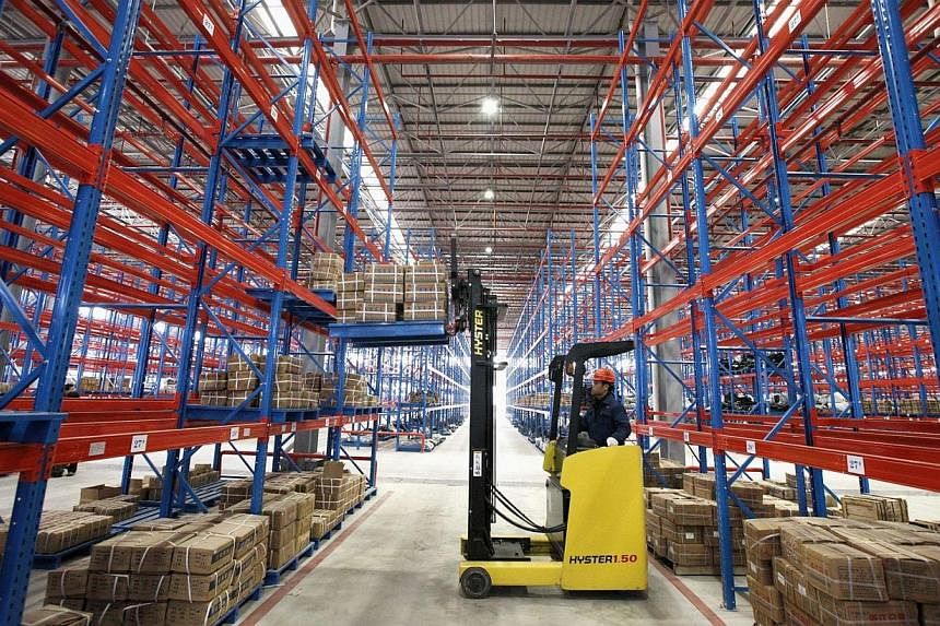 An employee works at a logistic center in Huaibei, Anhui province on Jan 20, 2015. China's manufacturing growth stalled for the second straight month in January and companies had to cut prices at a faster clip to win new business, adding to worries a