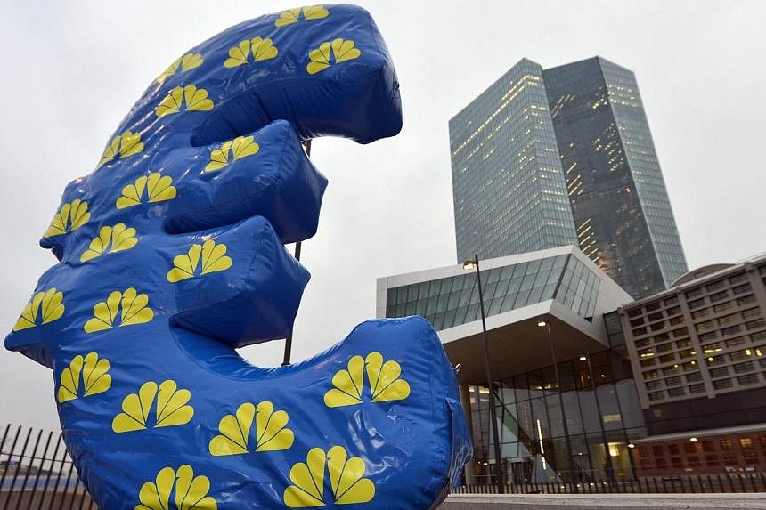 An inflated Euro sign of the news channel CNBC is placed in front of the European Central Bank (ECB) in Frankfurt, Germany on Jan 22, 2015. -- PHOTO: EPA
