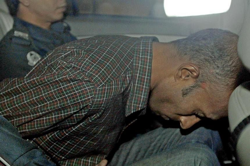 James Raj Arokiasamy, accused of hacking into the Ang Mo Kio Town Council’s website, is being driven away after a court appearance on Nov 15, 2013. The alleged hacker pleaded guilty to 39 charges of computer misuse on Friday. -- ST PHOTO: WONG KWAI