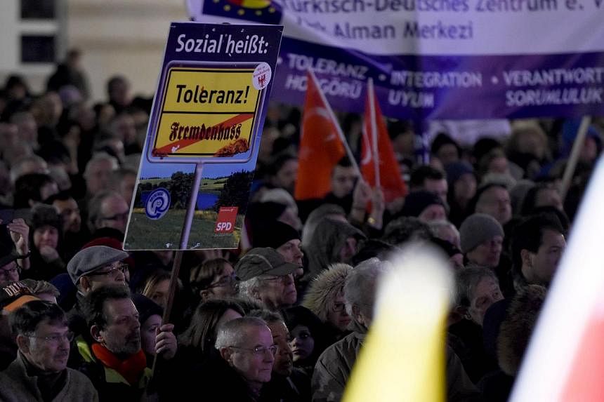 A poster saying "social means tolerance" at a Muslim community rally at Berlin's Brandenburg Gate last week to condemn the Paris attacks, urge tolerance and send a rebuke to a growing anti-Islamic movement.