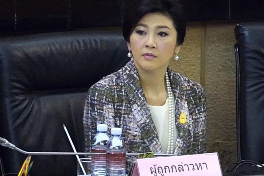Ousted Thai prime minister Yingluck Shinawatra looks on during impeachment proceedings by the military-stacked National Legislative Assembly (NLA) at the parliament in Bangkok on Jan 22, 2015. -- PHOTO: AFP