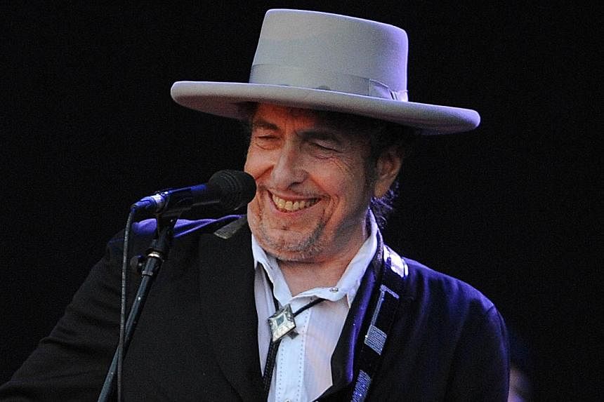 Bob Dylan performing at the Vieilles Charrues music festival in this July 22, 2012, file photo, in Carhaix-Plouguer, western France. Dylan is giving away his latest album for free to random retirees as the 73-year-old rock legend said he is at at pea