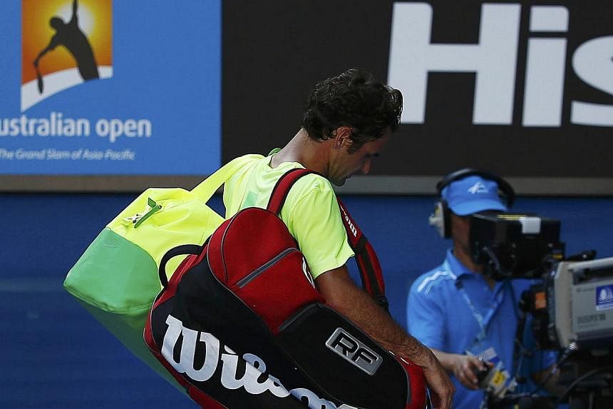 Switzerland's Roger Federer walking off the court after being defeated by Andreas Seppi of Italy in their men's singles third round match at the Australian Open 2015 tennis tournament in Melbourne on Jan 23, 2015. -- PHOTO: REUTERS