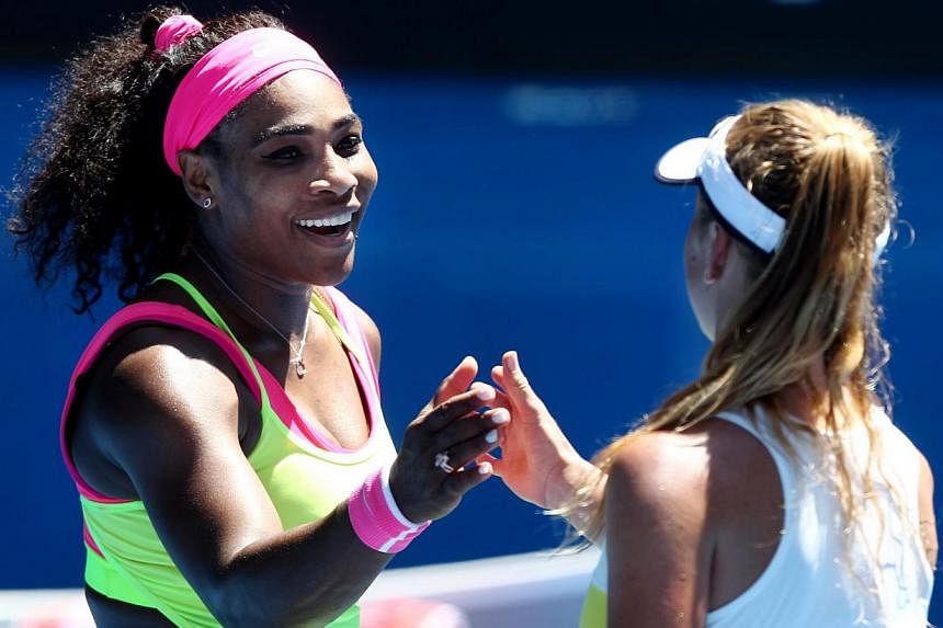 Serena Williams of the USA (left) touches hands with Elina Svitolina of the Ukraine (right) after winning in their third round match of the Australian Open tennis tournament at Melbourne Park in Melbourne, Australia, Jan 24, 2015. -- PHOTO: EPA