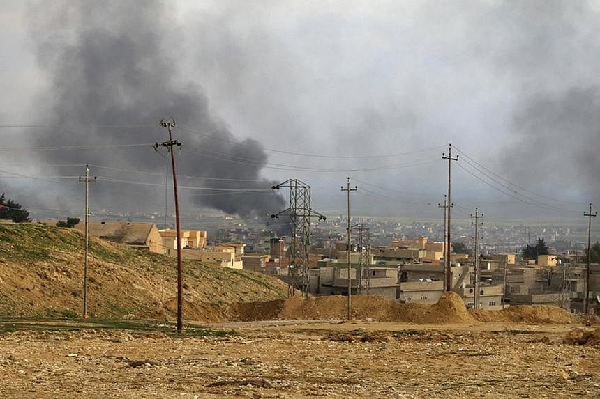 A general view shows the town of Sinjar as smoke rises from what activists said were US-led air strikes on Dec 22, 2014. Syrian President Bashar al-Assad has said US-led air strikes against Islamic State in Iraq and Syria (ISIS) militants in Syria sh