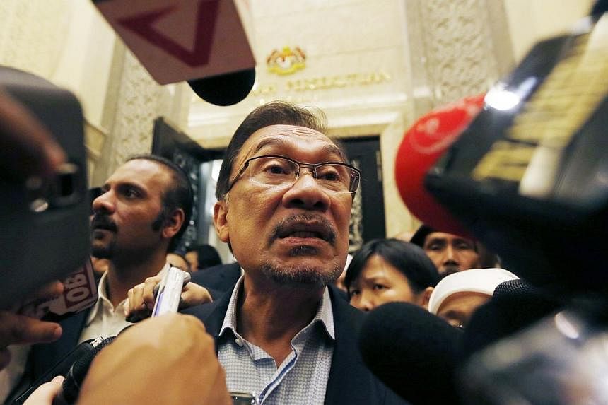 Malaysia's opposition leader Anwar Ibrahim speaks to the media after his final appeal against a conviction for sodomy was concluded at the Palace of Justice in Putrajaya on Nov 7, 2014.&nbsp;Mr Anwar will learn on Feb 10 whether he will be jailed for