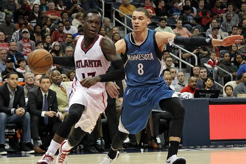 Atlanta Hawks guard Dennis Schroder (17) drives past Minnesota Timberwolves guard Zach LaVine (8) in the fourth quarter at Philips Arena. Hawks forward Paul Millsap tallied 20 points and six assists as Atlanta won their 16th straight game with a 112-