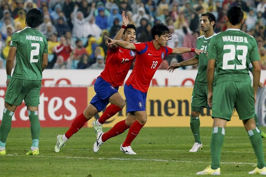 South Korea's Kim Young-Gwon (no. 19) celebrates with teammate Lee Jeong-Hyeop after scoring the second goal against Iraq during their Asian Cup semi-final football match at the Stadium Australia in Sydney on Jan 26, 2015.&nbsp;-- PHOTO: REUTERS
