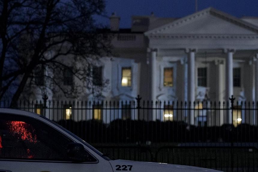 A member of the Secret Service's Uniformed Division sits in his car on Pennsylvania Avenue outside the White House on Jan 26, 2015, in Washington, DC.&nbsp;The &nbsp;Secret Service recovered a small, remote-controlled drone on the White House grounds
