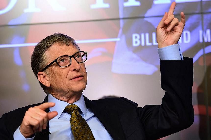 Bill Gates, founder of the Bill and Melinda Gates Foundation, gestures as he takes part in a discussion organised by British magazine The Economist about expected breakthroughs in the next 15 years in health, education, farming and banking on Jan 22,