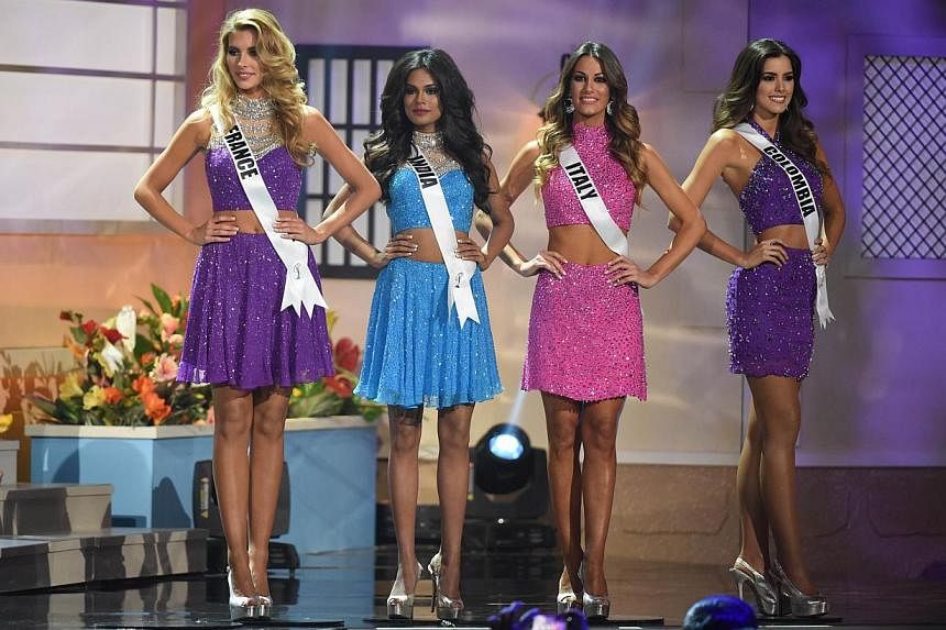 (Left to right): Miss France Camille Cerf; Miss India Noyonita Lodh; miss italy Valentina Bonariva; and Miss Colombia Paulina Vega pose on stage during the 63rd Annual Miss Universe Pageant at Florida International University on Jan 25, 2015, in Miam