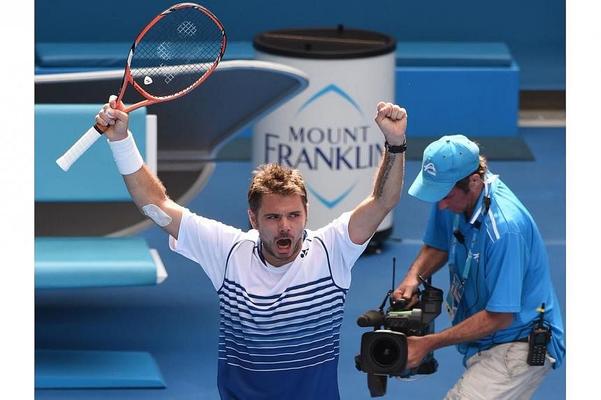 Stan Wawrinka of Switzerland celebrates his victory over Guillermo Garcia-Lopez of Spain in their men's singles match on day eight of the 2015 Australian Open tennis tournament in Melbourne on Jan 26, 2015.&nbsp;-- PHOTO: AFP