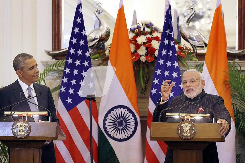 India prime minster Narendra Modi (right) watched by US President Barack Obama during a joint press conferencen at Hyderabad House in New Delhi, India on Jan 25, 2015.&nbsp;-- PHOTO: EPA
