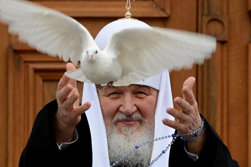 Russian Orthodox Patriarch Kirill releases a white dove to mark Annunciation Day at the Kremlin in Moscow in a file photo taken on April 7 last year. -- PHOTO: AFP