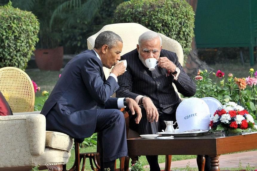 Indian Prime Minister Narendra Modi (right) in 'One on One' talks while having tea with US President Barack Obama (left) in the gardens of Hyderabad House, in New Delhi on Sunday as seen in a handout image provided by the Press Information Bureau of 