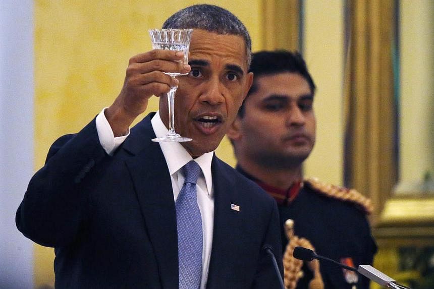 United States President Barack Obama delivers a toast as he attends an official state dinner with India's President Pranab Mukherjee and Prime Minister Narendra Modi at the Rashtrapati Bhavan presidential palace in New Delhi on Sunday. -- PHOTO: &nbs