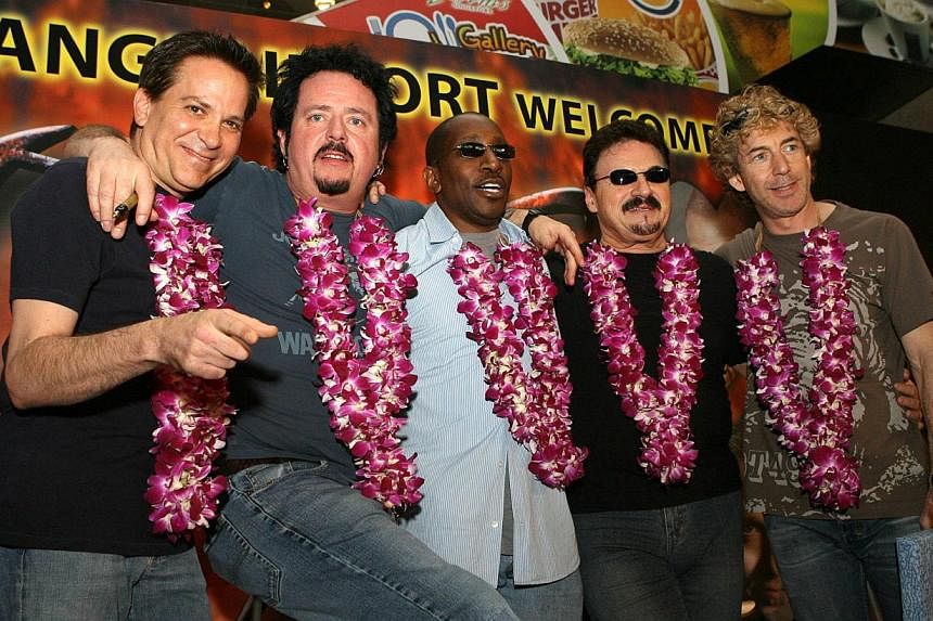 &nbsp;Legendary US rock group TOTO pose for photographs upon arrival at Changi Airport in Singapore in a 2006 file photo. -- PHOTO: AFP