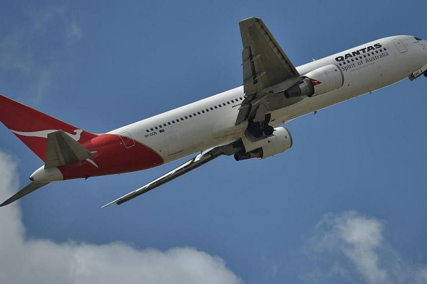 Qantas Airways will be restructuring its international tariffs to absorb fuel surcharges into base fares, adding that lower oil prices put airlines in a better position to invest in new aircraft, lounges and routes. -- PHOTO: AFP&nbsp;