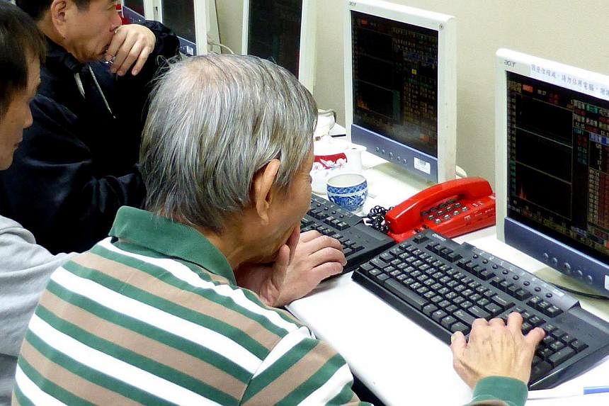 Investors checking share price data at a stock brokerage in Taipei, Taiwan, on Jan 26, 2015. Asian shares moved higher on Tuesday and the euro clung to rare gains, relieved that European markets had weathered Greece's election outcome without much di