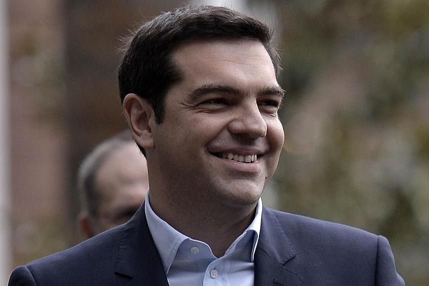 Greece's new prime minister, Mr Alexis Tsipras, leaving the presidential palace after the swearing-in ceremony in Athens on Jan 26, 2015. -- PHOTO: AFP