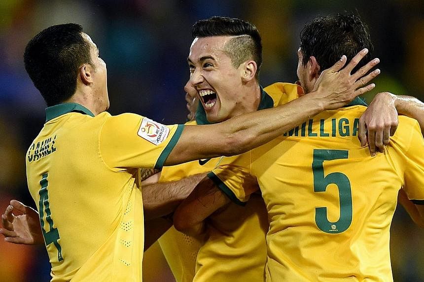 Australia's Jason Davidson celebrating his goal with Mark Milligan and Tim Cahill during the Semi Final Asian Cup match between Australia and the United Arab Emirates at Hunter Stadium in Newcastle, Australia, on 27 Jan 2015. First-half goals from de