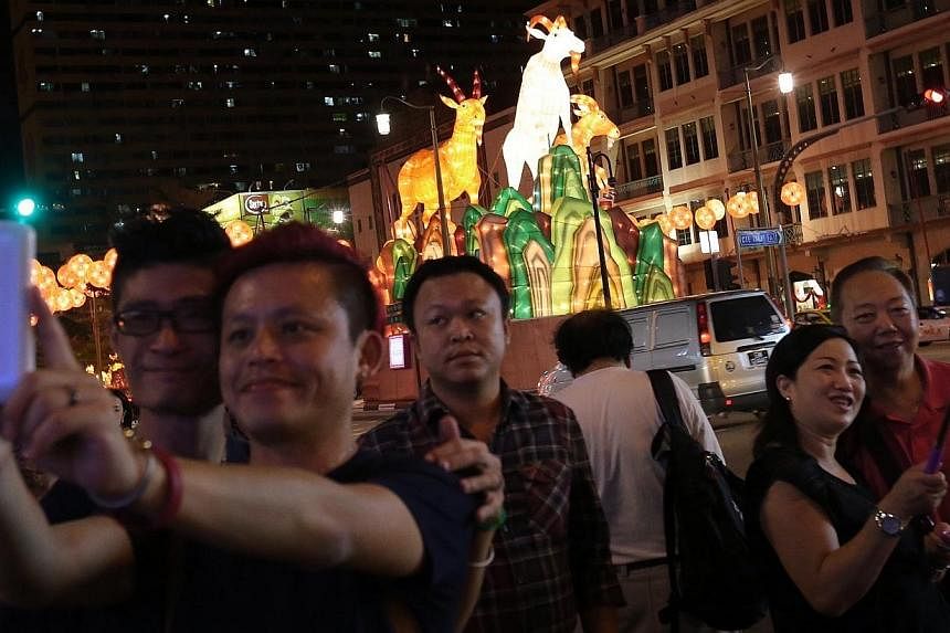 Members of the public taking selfies against the backdrop of the 10m-high centerpiece of the Chinatown street light-up, which sees three majestic goats perched on top a cliff. Chinatown will come alight this Saturday with 338 goat-shaped lanterns in 