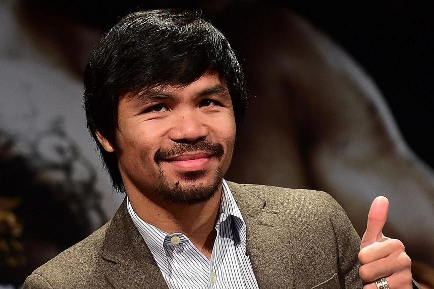 Filipino boxing star Manny Pacquiao at a press conference in Los Angeles, California, on Sept 3, 2014. Pacquiao has a plan in place if yet another bid to fight Floyd Mayweather fails - a May 30 bout, possibly against England's Amir Khan. -- PHOTO: AF