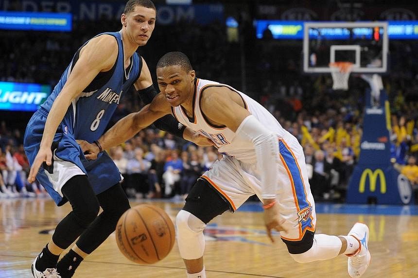 Oklahoma City Thunder guard Russell Westbrook (right) battles for the ball with Minnesota Timberwolves guard Zach LaVine (8) during the fourth quarter at Chesapeake Energy Arena. Westbrook and the Thunder easily defeated the Timberwolves 92-84 on Tue