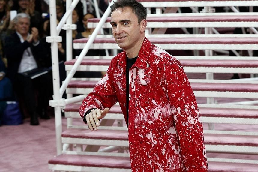 Belgian fashion designer Raf Simons acknowlegding the public at the end of the Christian Dior 2015 haute couture spring-summer collection fashion show. -- PHOTO: AFP